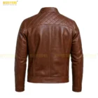 Distressed Brown Leather Texture Close-Up. Detailed close-up shot focusing on the leather’s natural grain, handcrafted distressed finish, and high-quality texture used in the men’s vintage leather jacket.. Close-up of distressed brown leather texture on men’s jacket, highlighting natural grain, hand-finished aging, and premium craftsmanship