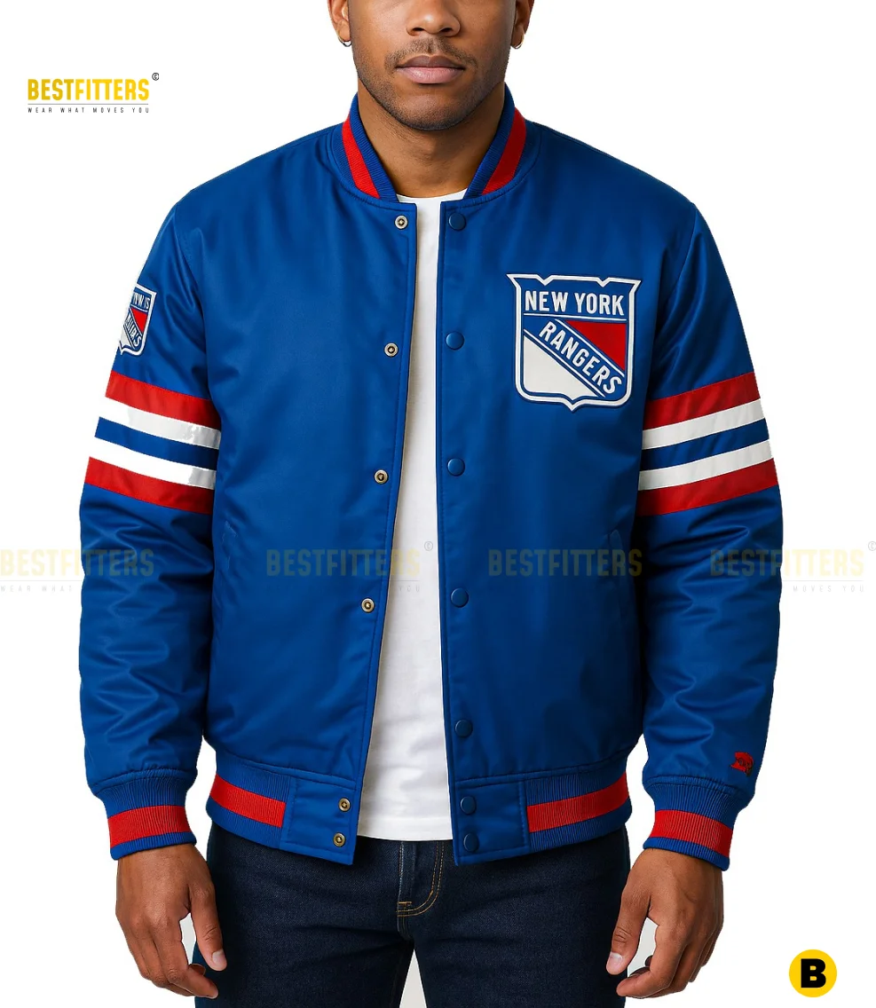 Men’s blue varsity jacket with full-snap front closure, ribbed cuffs and waistband, embroidered chest patch, and red-and-white striped sleeves, styled with denim pants.